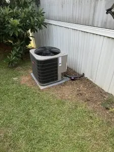 Condenser beside a home