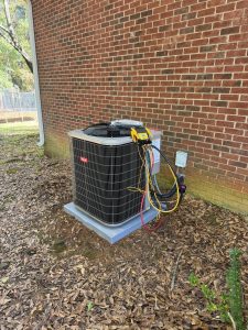 Condenser beside a brick building with gauges attached