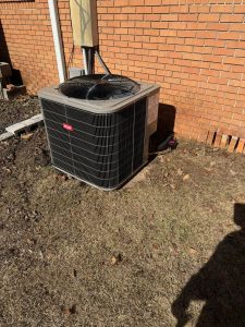 Bryant condenser beside a brick home