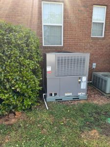 Packaged unit beside a brick home
