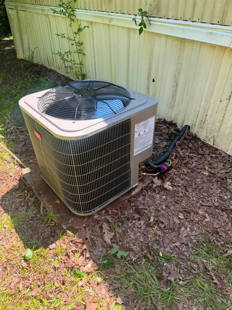 New condenser beside a home